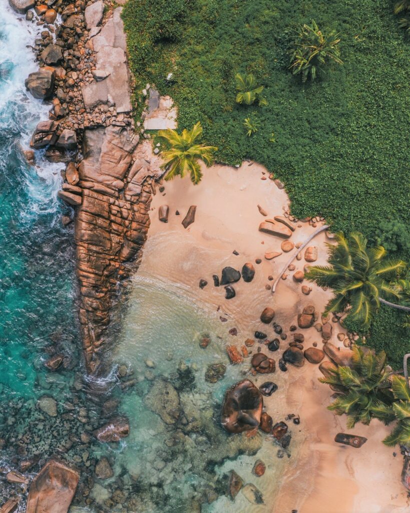 Seychelles drone shot of beach cliffs