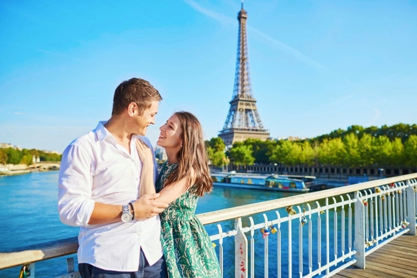 Romantic couple at iconic Eiffel tower in Paris, France
