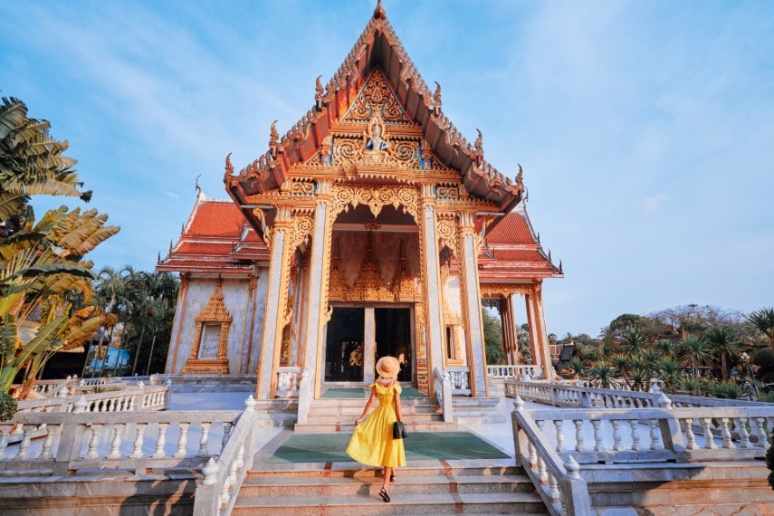 Young woman in hat and yellow dress in Thailand