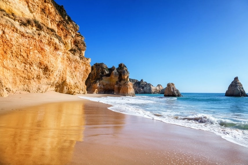 secret sandy beach among rocks and cliffs in Algarve, Portugal