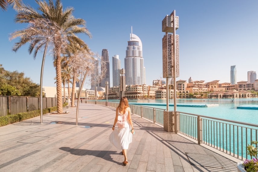 Happy tourist girl wearing beautiful dress in Dubai