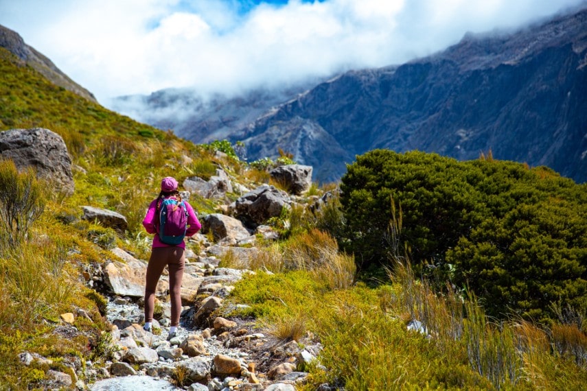 hiker girl enjoys a scenic path in New Zealand in September