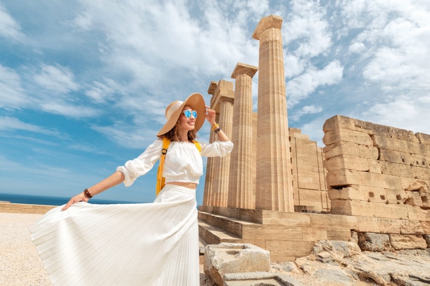 Happy girl wearing cool outfit visiting in Greece in October