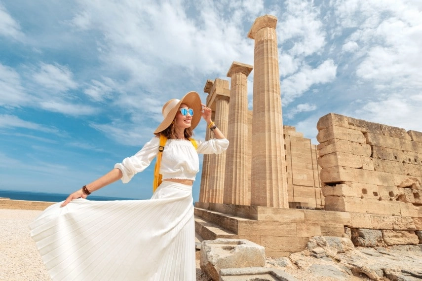 Happy girl wearing cool outfit visiting in Greece in October