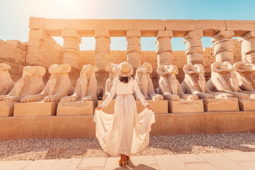 A happy tourist girl with cool outfit visiting Egypt in September