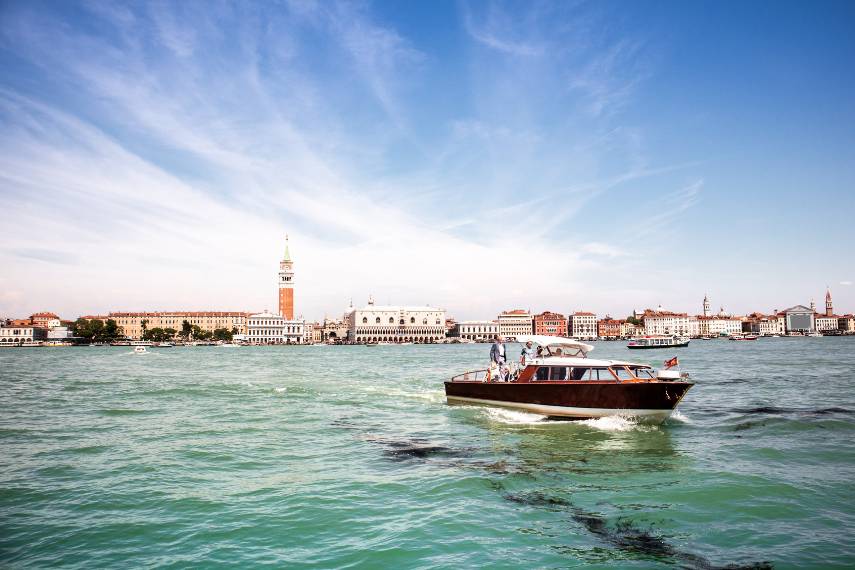 A hotel river shuttle cruises along Venice's Grand Canal