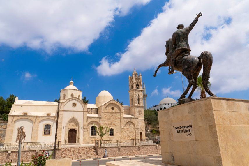 Statue of Ataturk on a horse and old orthodox Ayios Synesios, Karpas Peninsula, Northern Cyprus
