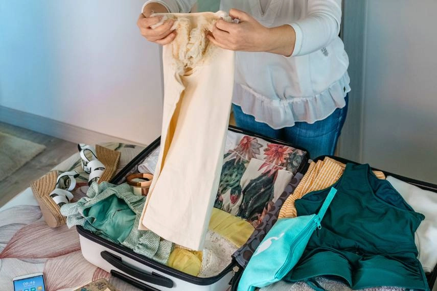 Woman preparing suitcase to visit Malta