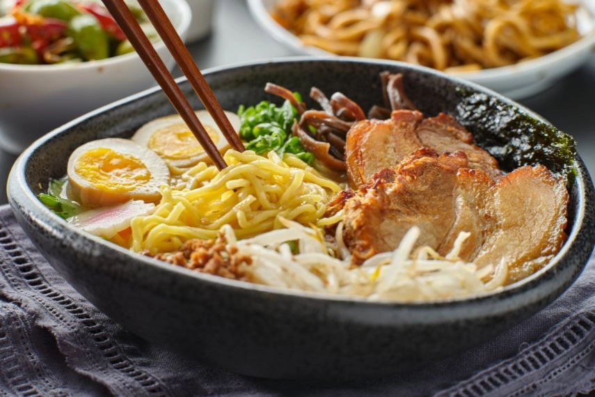 eating japanese tonkotsu ramen with chopsticks