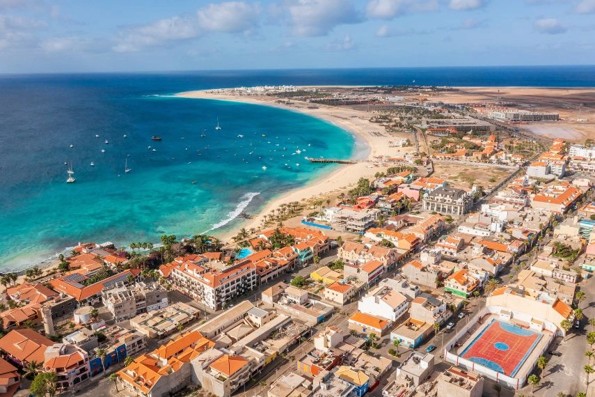 Pier and boats on turquoise water in city of Santa Maria, Sal, Cape Verde
