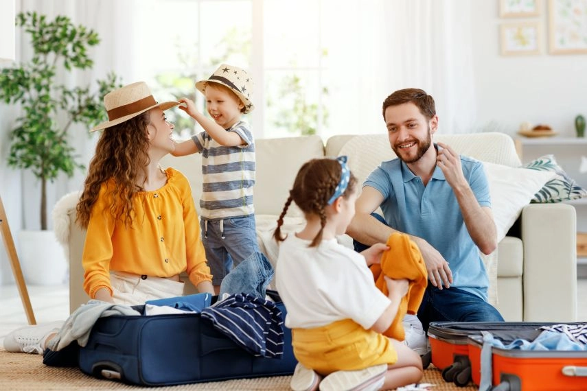 family preparing travel luggage at home for holiday trip