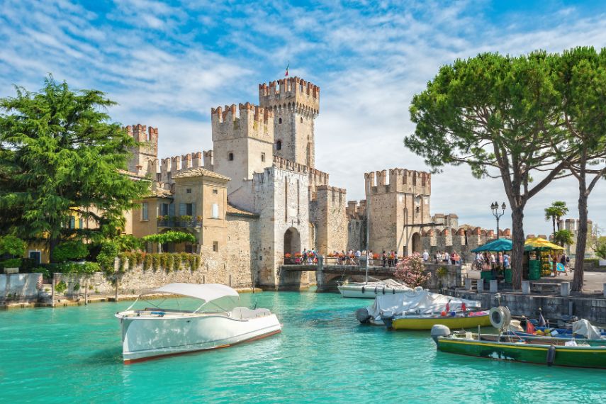 Do boating near the Rocca Scaligera castle on the island of Sirmione, lake Garda, Italy