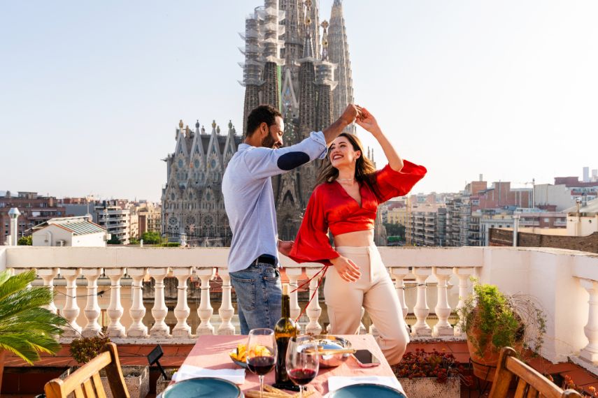 beautiful happy couple of lovers dating on rooftop balcony at Sagrada Familia, Barcelona