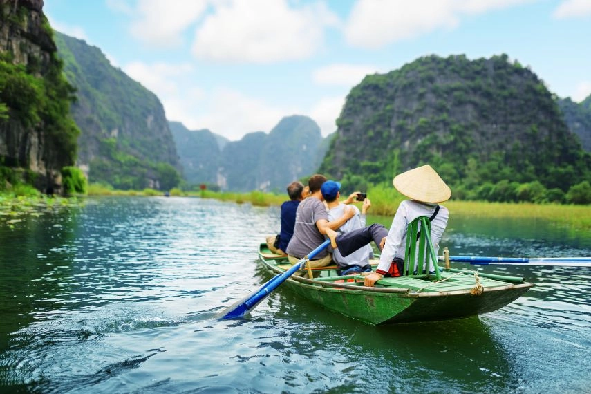 a scenic boat tour through the limestone karst landscape of Ninh Binh, Vietnam