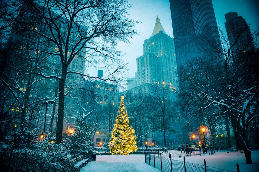 christmas tree surrounded by the skyscrapers of midtown manhattan in madison square park new york city 