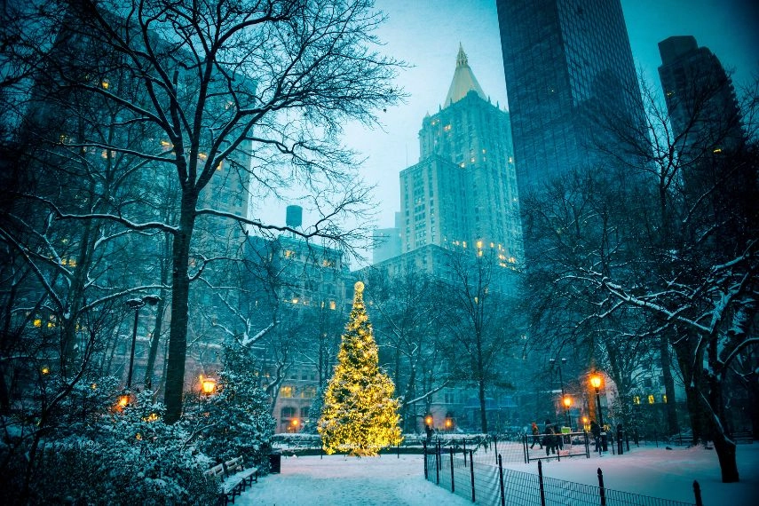 christmas tree surrounded by the skyscrapers of midtown manhattan in madison square park new york city