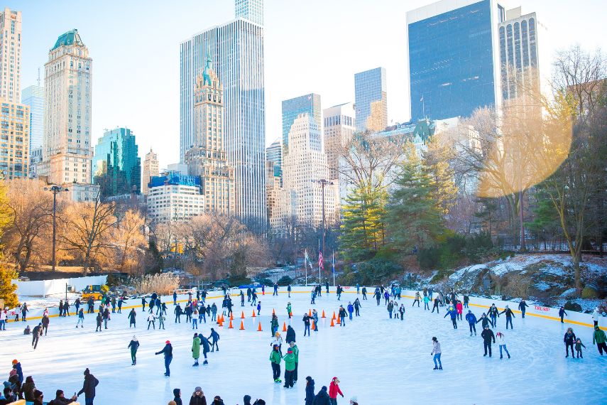 Ice skaters having fun in New York Central Park in winter 