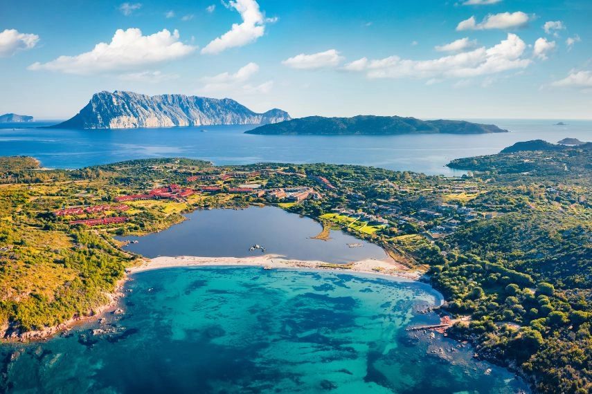 Breathtaking spring scene of Salina Bamba beach with Tavolara mountain on background. Captivating morning view of Sardinia island, Italy, Europe