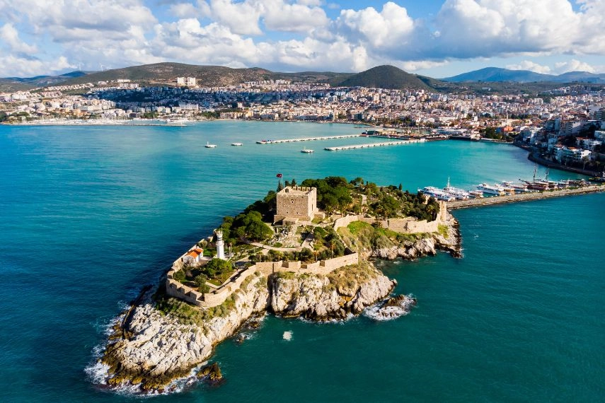 View of Guvercinada or Pigeon Island in the Aegean Sea with the Kusadasi Pirate castle in summer day, Turkey