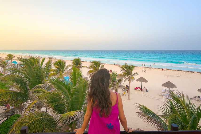 Young woman watching the beautiful Cancun beach at sunset