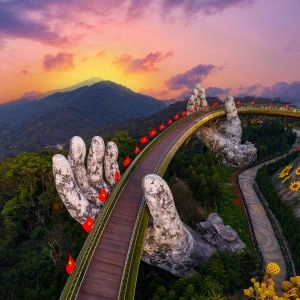 Golden bridge at sunset in ba na hills two hands