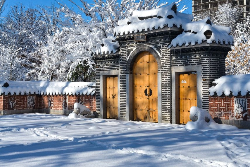 snow on traditional Korean style gates in Seoul National park during winter season (Tashkent, Uzbekistan)