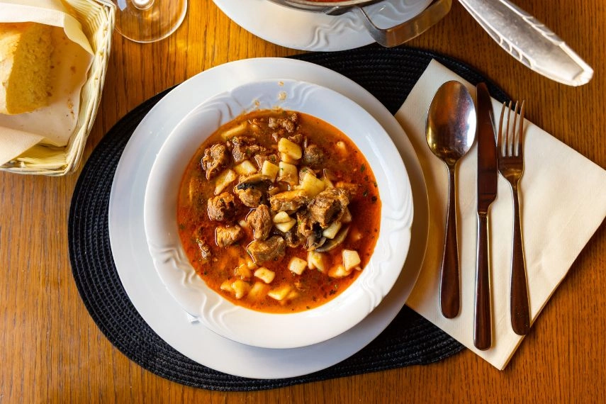 Traditional Croatian cobanac stew with beef and pasta in rich paprika sauce