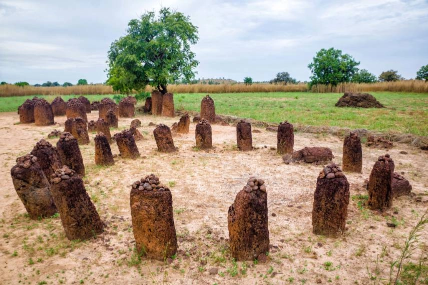 Historic stone-topped clay pillars in a field in The Gambia.