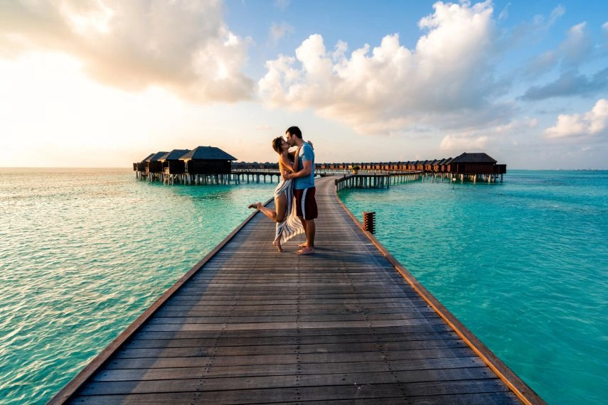 couple enjoying a sunrise in the Maldives