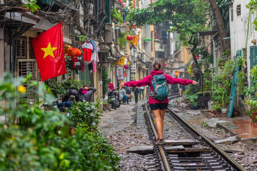 Woman walking on the railway in Hanoi, Vietnam