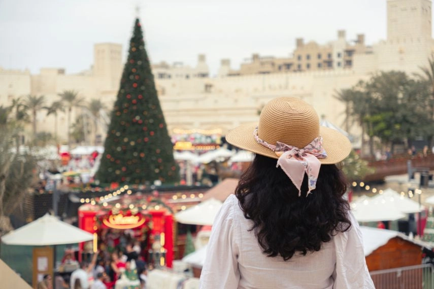 woman in hat enjoying Christmas market in Dubai